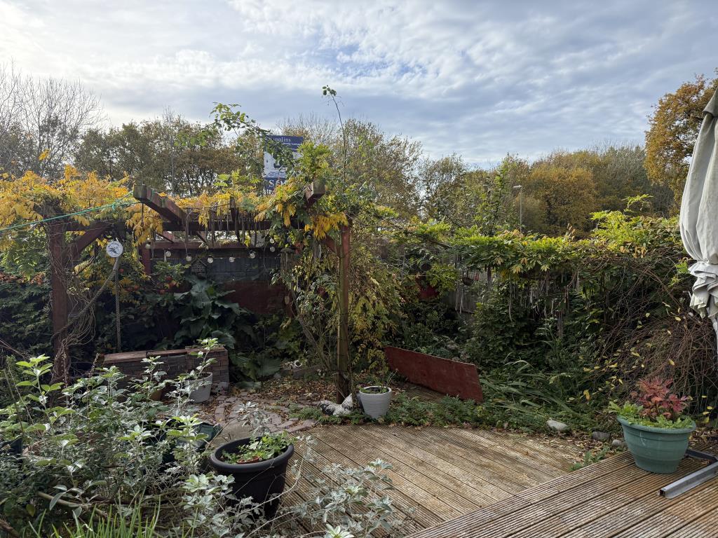 Lot: 73 - THREE-BEDROOM SEMI-DETACHED HOUSE WITH GARAGE IN NEED OF IMPROVEMENT - Garden with decking area and raised pond